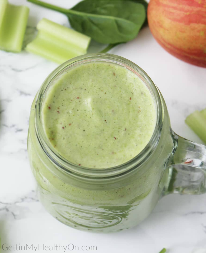 Smoothie with celery, spinach, apple, and banana.